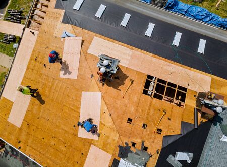 Removal of old roof replacement with new shingles of an apartment buildingの写真素材