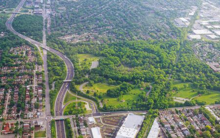 Aerial wide panorama of blue sky with white clouds and green residential area landscape in small...