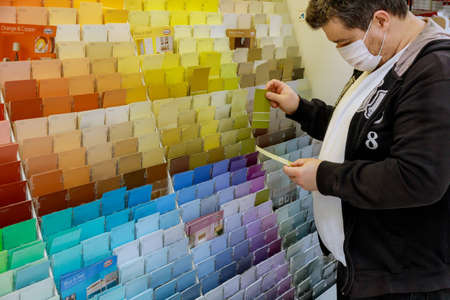 New York, NY USA - JUNE 14, 2020: Man on mask shopping on walmart local store chooses paint in the hardware store with coronavirus COVID-19のeditorial素材