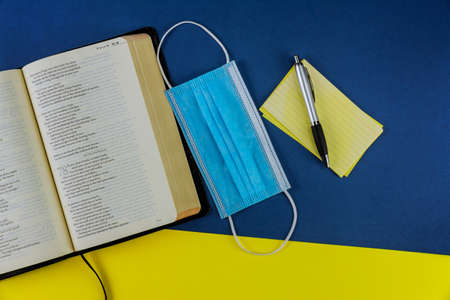 NewYork NY JUNE 11 2020: Protective a medical respiratory mask on Holy Bible Amid Covid-19 Pandemicのeditorial素材