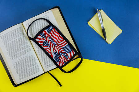 NewYork NY JUNE 11 2020: Holy open Bible with medical mask on the table
