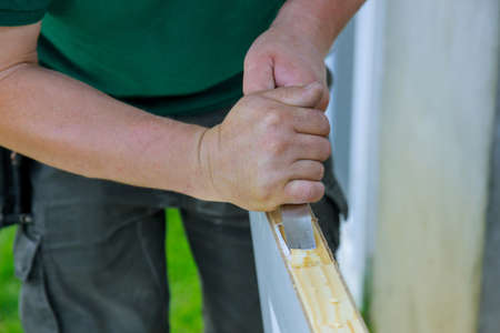 Carpenter working using a chisel a hinge wooden door a hinge is installing the doors
