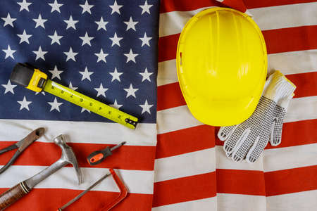 Patriotic American Flag with stars and stripes in the labor day different tools tape measure on USA flag backgroundの写真素材