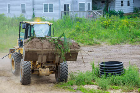 Bulldozer earthmoving on the leveling moving soil landscaping works using scoop