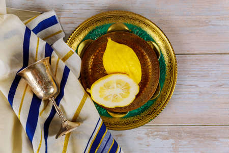 Jewish religious yellow citron etrog is used during holiday of Sukkot and tallit