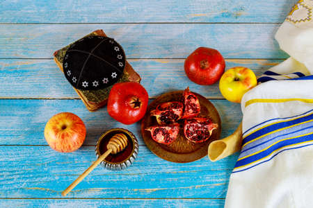 Table in the synagogue are symbols of Rosh Hashanah apple and pomegranate, shofar talith