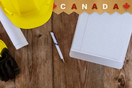 Canada with symbol patriotism happy Labor day with manny handy tools, notebook on wooden background top view.の写真素材