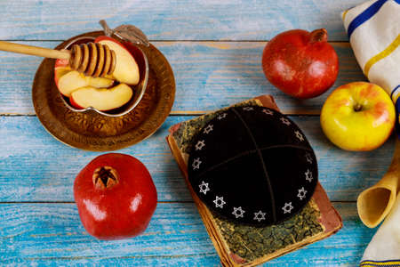 A jewish new year with honey for the apple and pomegranate holiday of Rosh Ha Shana Jewish praysの写真素材