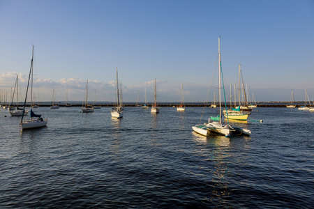 Minimalist landscape with boats in marina bay beautiful port on ocean in the sunny dayの写真素材