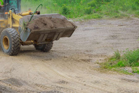 Earth-moving equipment, bulldozer digging ground during of moving earth a soil