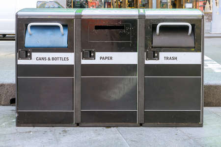 Trash waste bin street litter bins with cups of coffee on recycling garbage in New York Cityの写真素材