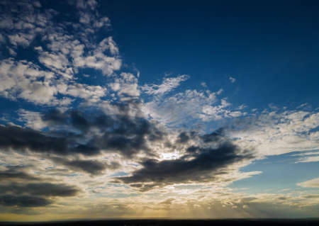 Dramatic soft early morning sunrise, beautiful pink violet orange clouds against blue sky