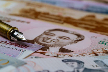 North Korean banknotes money won currency bill over pen for writingの写真素材
