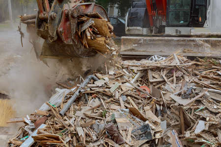 Caused by demolition of wooden house in trash debris outside of neighborhoods devastated by...