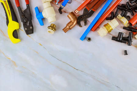 Various plumbers tools, pipe fittings on a home improvement plumbing materials including copper...