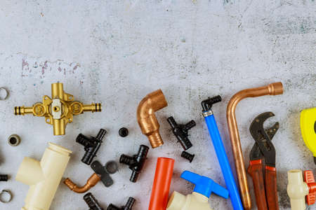 Various plumbers tools, pipe fittings on a home improvement plumbing materials including copper pipe, elbow joint, wrench and spanner.の写真素材
