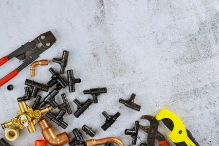 Polypropylene pipes, pipe cutting tools, adapters, work gloves in the water plumbing supply