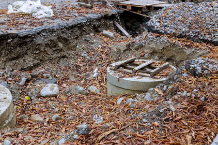 Repair work in the city, repair of laying utilities concrete well for communications buried in the...