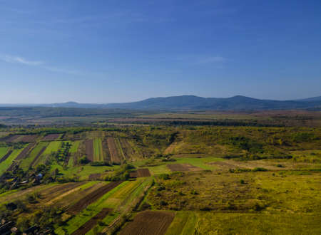 Aerial view of green farmland cultivated field from of the countrysideの写真素材