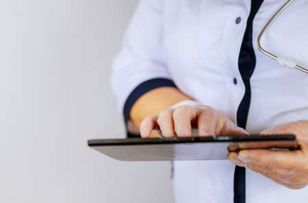 Medical doctor working woman using tablet computer standingの写真素材