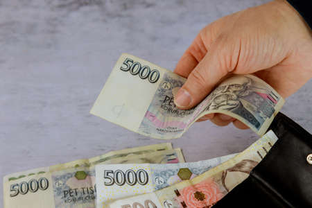 Man with hands of a Czech korun money on tableの写真素材