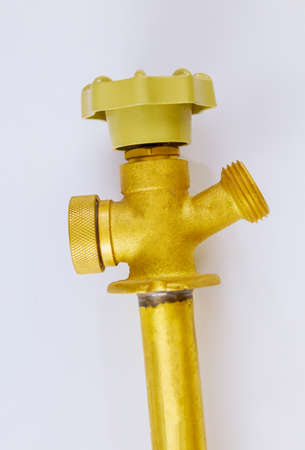 Multi turn brass hose bibb valve in the plumbing supply systems on isolated white background.