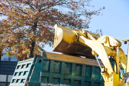Regular seasonal work on improving the public places city team removes the fallen leaves with an...