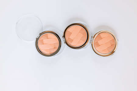 Palette of multicolor cosmetic make up with a eyeshadow palette, colorful shadows minimalism on isolated white backgroundの写真素材