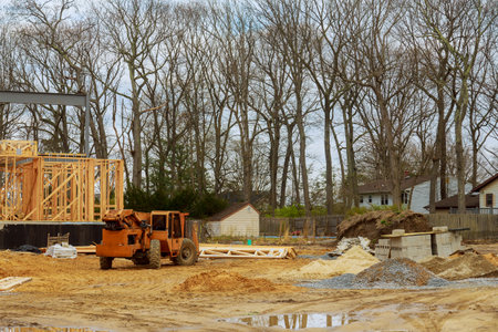 Wood building frame on new residential construction home framing home a boom truck forklift in the...