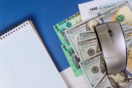 Stimulus economic tax return check 1040 US individual Income Tax Return with us money and spiral notepad,の写真素材
