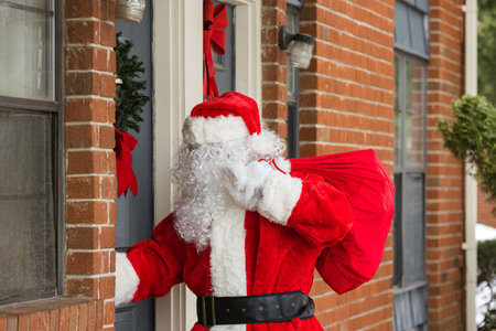 Santa Claus arrives with of Christmas presents at homeの写真素材
