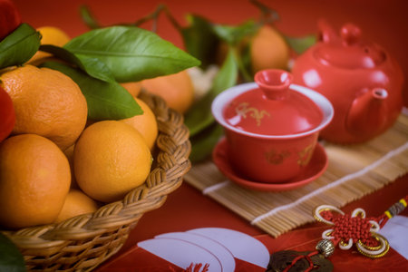 Chinese New Year decoration festival decorations of accessories in traditional container mandarin oranges on a red background on selective focusの写真素材