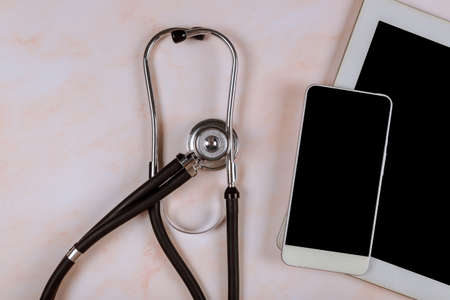 Workplace medical hospital office on the digital tablet computer with medical stethoscope on marble tableの写真素材
