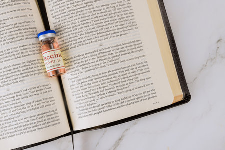 22 JANUARY 21 New York US 2021: Negative attitude of the church to vaccination with Holy Bible readings and prayer and covid-19 vaccine bottleのeditorial素材