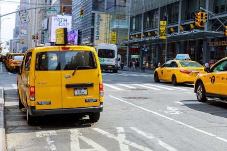 AUGUST 28 2020 NEW YORK NY USA: Group of yellow taxi cabs rush tourists Manhattan in New York City,...