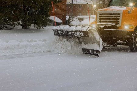 Tractor clears snow removal after snowfall blizzards clearing