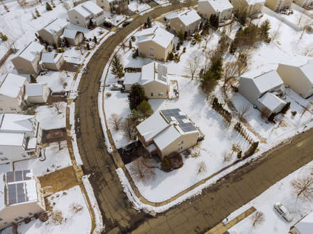 Aerial down view to on covered houses and roads at winter season courtyards covered snowの写真素材