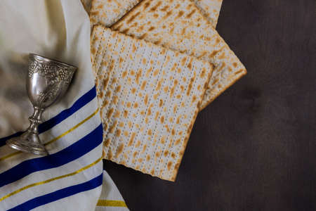 Orthodox Jewish prepared with cup wine kosher matzah on traditional jewish passover holiday
