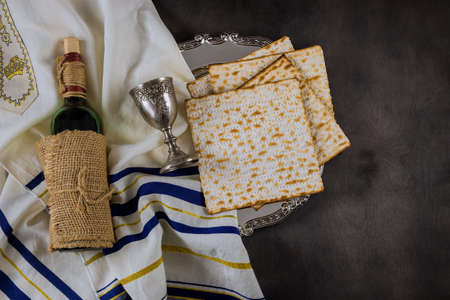 Passover holiday traditional celebration with cup wine kosher matzah unleavened bread on of Jewish...