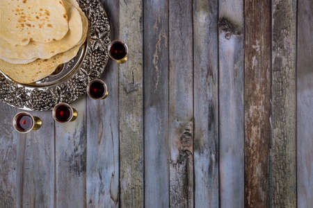 Matzoh passover jewish holiday celebration matzoh with kiddush four cup of red kosher wineの写真素材