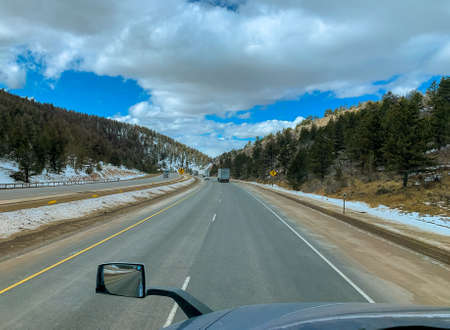 Wyoming Highway road in mountains covered with snow USAの写真素材