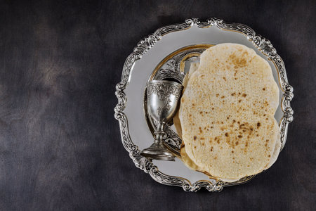Orthodox Jewish prepared with cup wine kosher matzah on traditional pesach jewish passover holiday