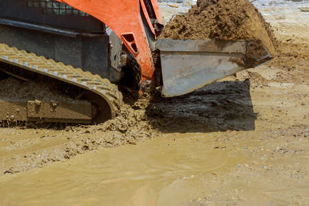 Small tractor digging land working with land