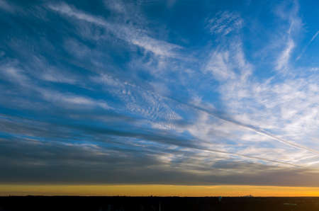 Panoramic red sun sunbeams sunset with blue skyの写真素材