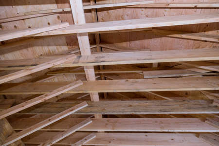 Residential attic under with wooden frame under construction house installation the roof of the...