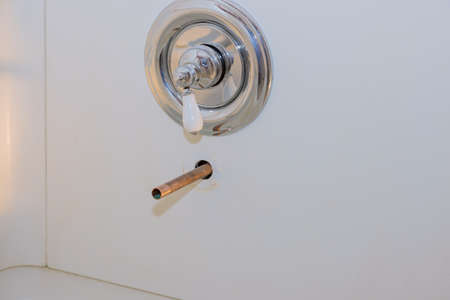 Plumbing installing copper pipe in the wall on new tap bathroomの写真素材