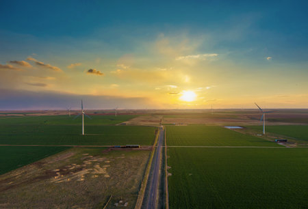 Wind turbine farms in the colorful sunset showing renewable energy works, wind energy blows into West Texasの写真素材