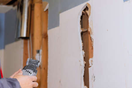 Repair of home on cutting gypsum plasterboard plaster hand sawzall toolの写真素材