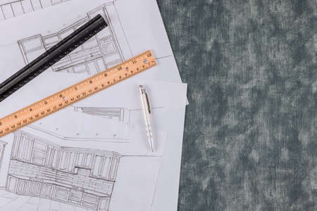 Designer makes a kitchen blueprint according to the drawing of an architectural projectの写真素材