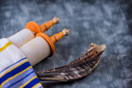 Prayer shawl in the shofar horn on soft focus Jewish torah scrollの写真素材